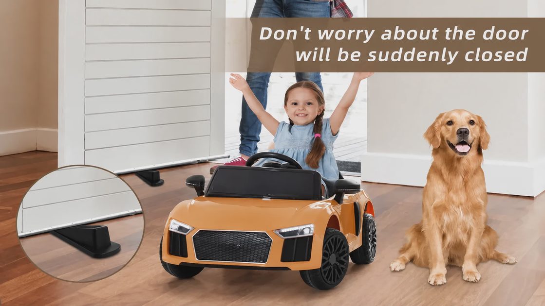 Child riding toy car inside house safely with a rubber door stopper preventing sudden door slamming.